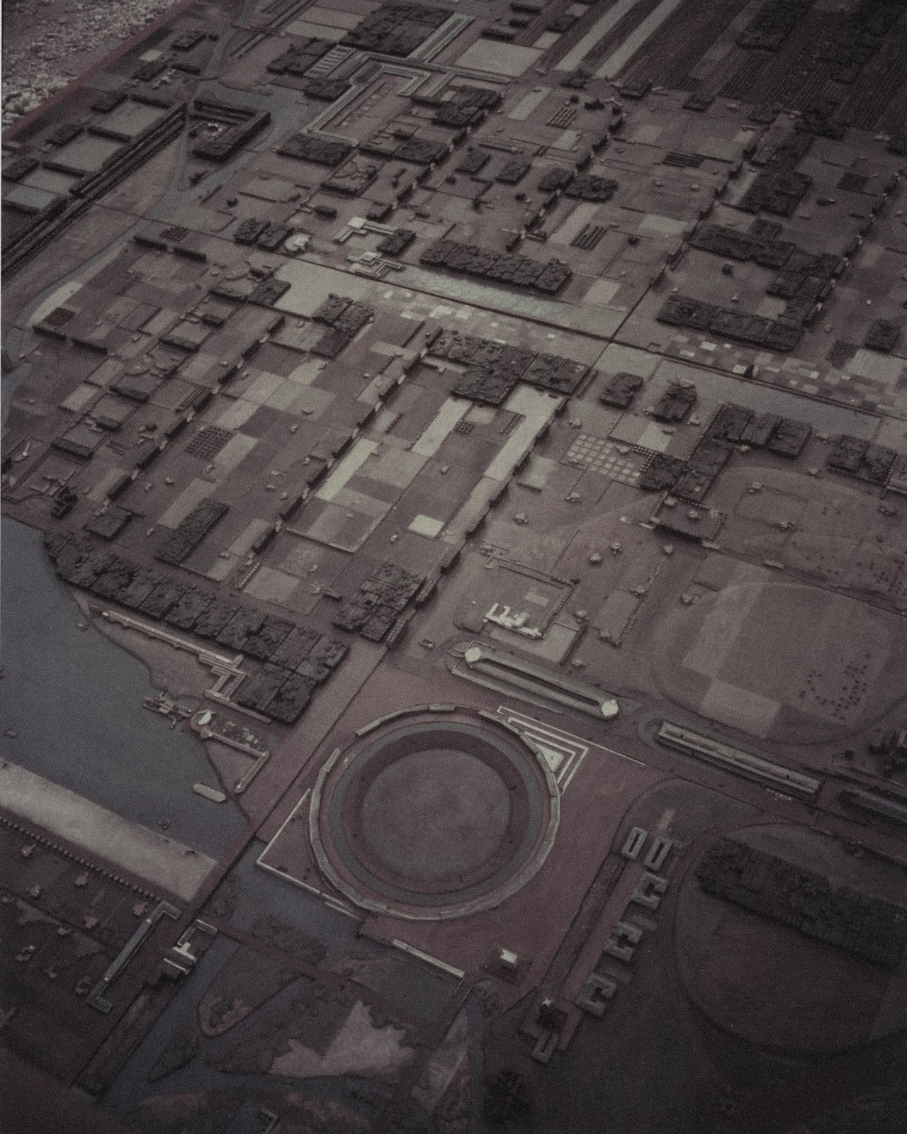 An aerial view of a detailed scale model of a planned city, blocks laid out to the horizon.