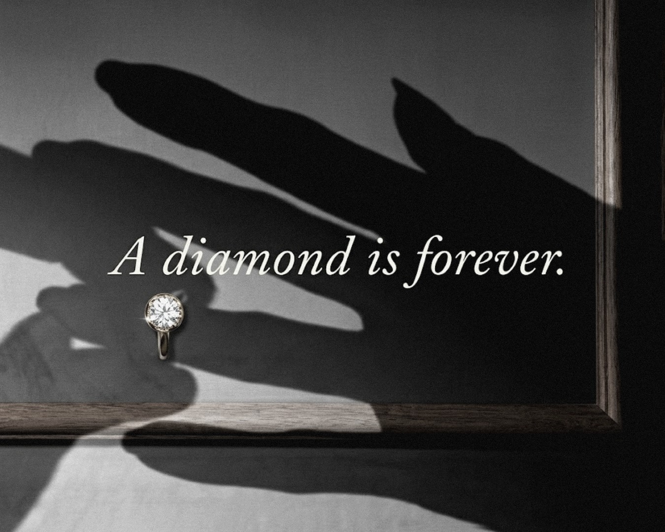 A De Beers advertisement: a gold solitaire ring beneath the line, A diamond is forever.